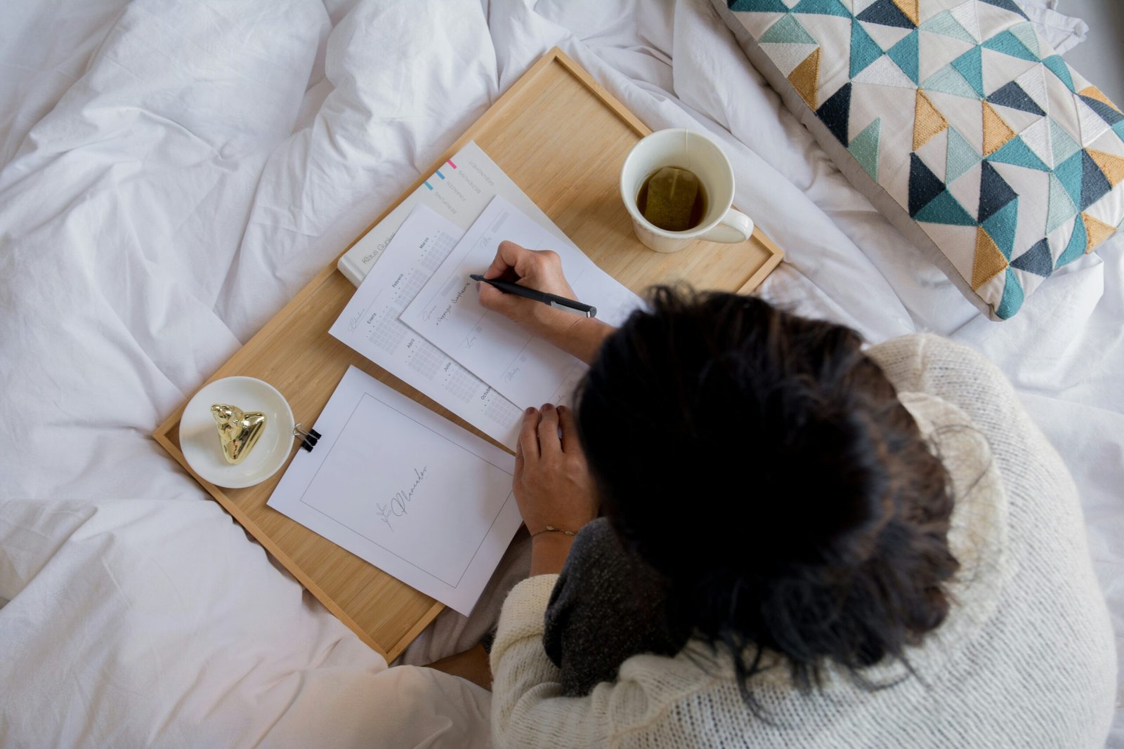Person enjoying peaceful morning habits with coffee and self-care journal