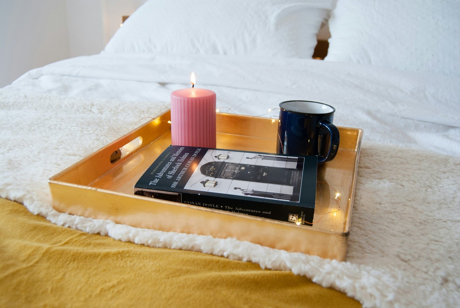 Morning wellness routine with a book, tea, and candle