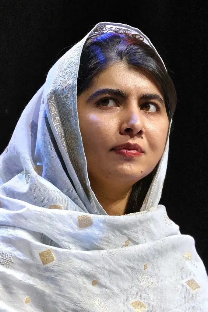 Malala Yousafzai holding a book, symbolizing education, activism, and freedom of speech for girls