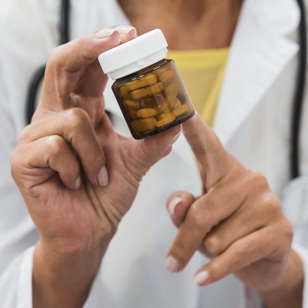 A health professional is pointing to a supplement to be tested. 