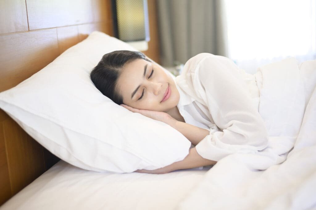 Young woman sleeping in her bed at home