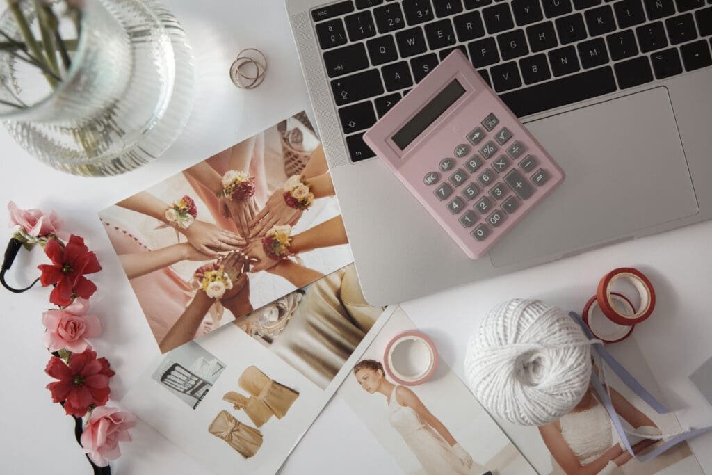Flat lay of laptops, notebooks, and fashion tools used for planning a 90-day fashion content calendar.