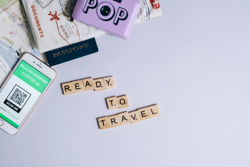 Flat lay of a travel planner, passport, health kit, and stylish outfit representing a balanced travel content strategy.